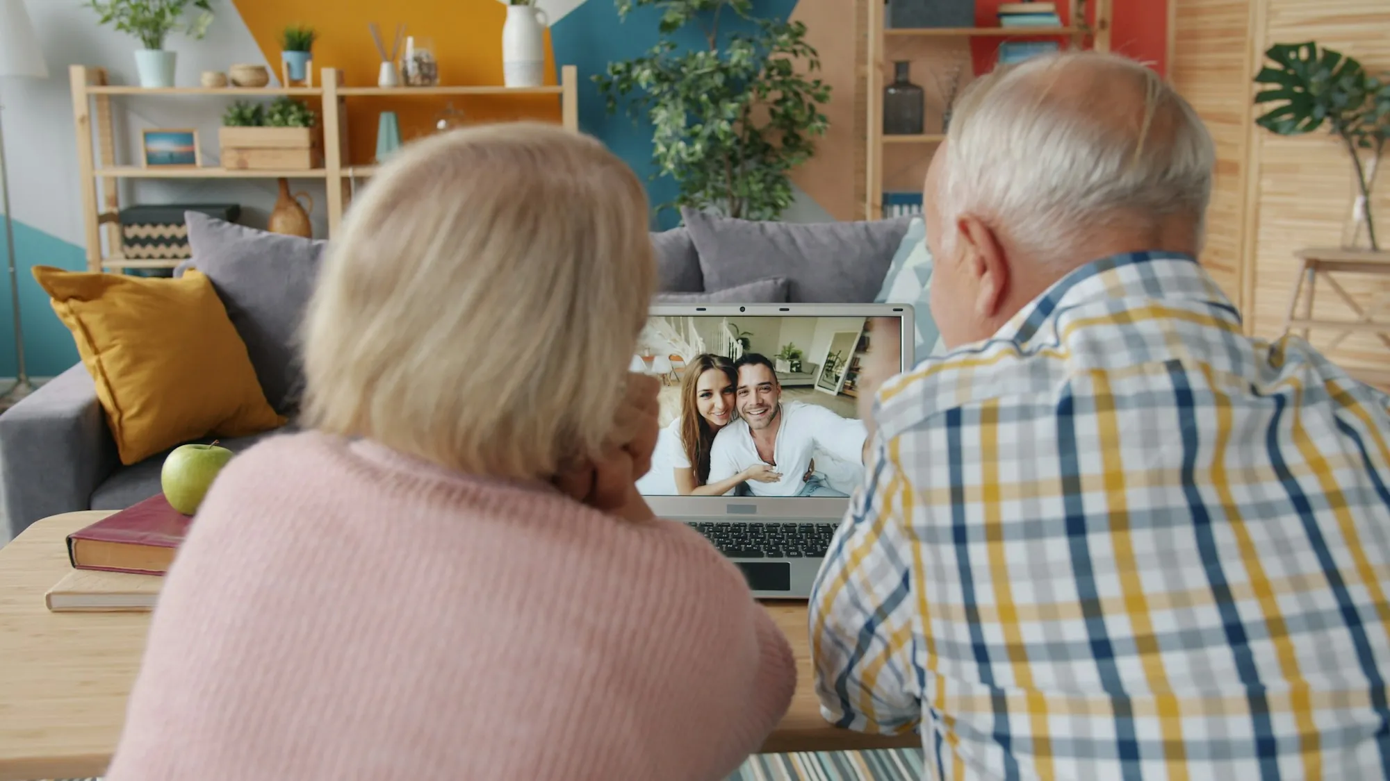 Older couple on a video call at their laptop
